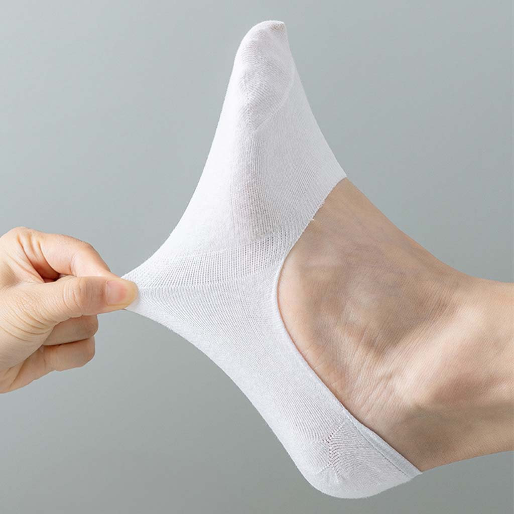 A white low-cut ankle sock being stretched by a hand, shown worn on a foot against a plain light gray background.